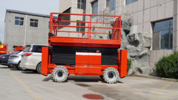Side view of Scissor Lift highlighting its lifting platform, robust treaded tires, and side control panel
