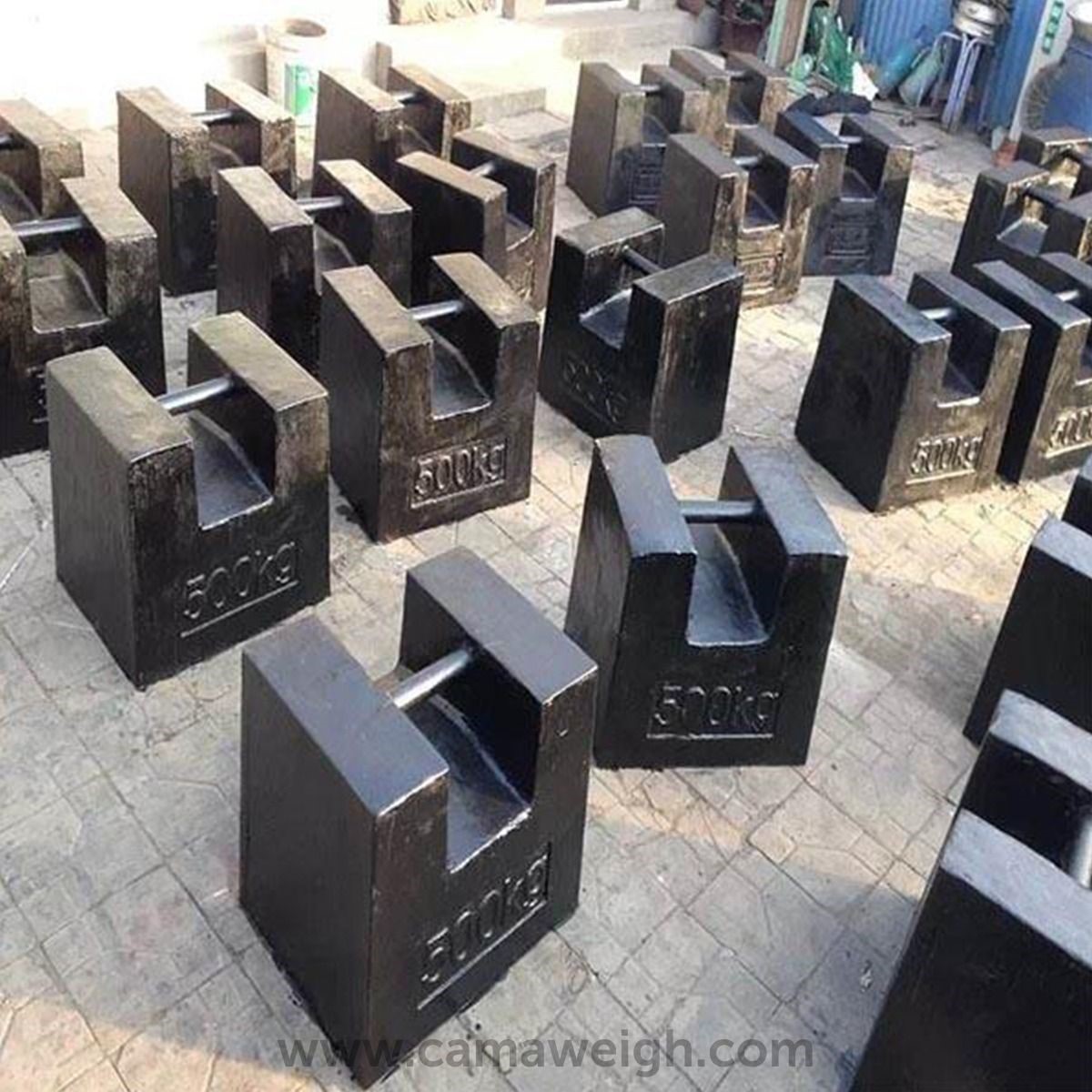 A cluster of 500 Kg Heavy Duty Cast Iron Weights displayed for sale by Camaweigh